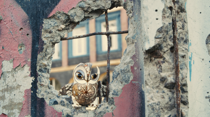A porcelain owl sits inside of a blown-out wall in a still from the film Porcelain War, screening at SIFF 2024.